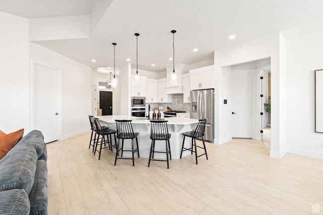 423 W Fitness Way, Ivins, UT 84738 - kitchen featuring stainless steel appliances, open floor plan, tasteful backsplash, a breakfast bar, and white cabinetry