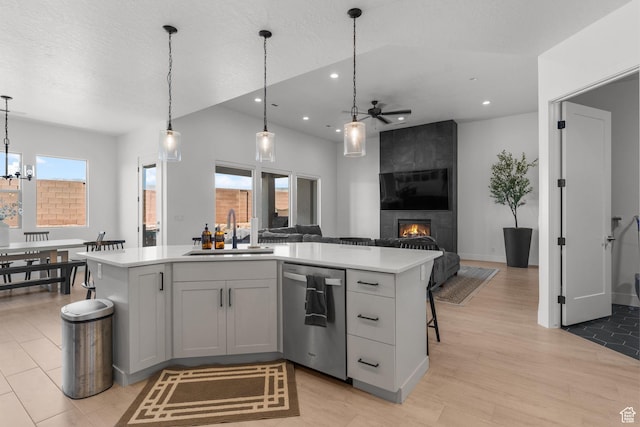 423 W Fitness Way, Ivins, UT 84738 - kitchen with dishwasher, a sink, a ceiling fan, light countertops, and a large fireplace