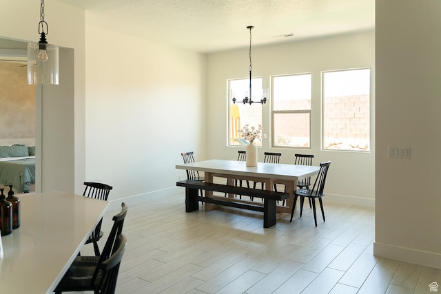 423 W Fitness Way, Ivins, UT 84738 - dining area with baseboards, a chandelier, and light wood-style flooring