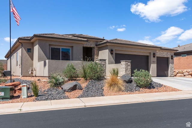 423 W Fitness Way, Ivins, UT 84738 - prairie-style home featuring a garage, stucco siding, concrete driveway, stone siding, and cooling unit