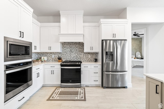 423 W Fitness Way, Ivins, UT 84738 - kitchen with appliances with stainless steel finishes, light countertops, white cabinetry, and custom range hood