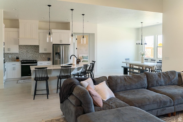 423 W Fitness Way, Ivins, UT 84738 - living area with light wood-style flooring, a chandelier, baseboards, and recessed lighting