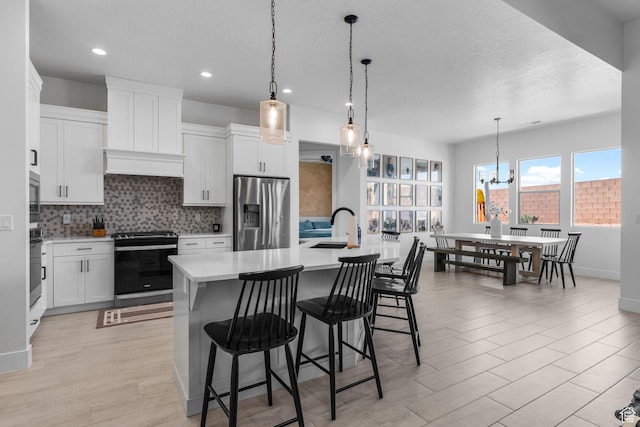 423 W Fitness Way, Ivins, UT 84738 - kitchen with stainless steel appliances, light countertops, backsplash, a sink, and a textured ceiling