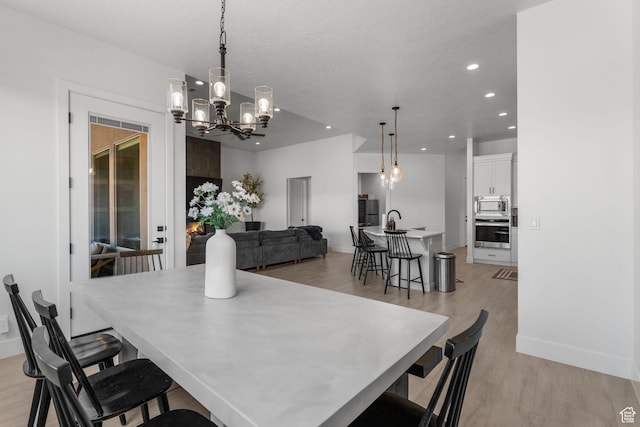 423 W Fitness Way, Ivins, UT 84738 - dining room with a chandelier, light wood finished floors, recessed lighting, and baseboards