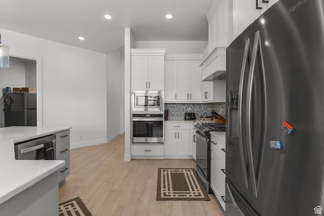 423 W Fitness Way, Ivins, UT 84738 - kitchen featuring appliances with stainless steel finishes, light countertops, white cabinets, light wood-type flooring, and recessed lighting