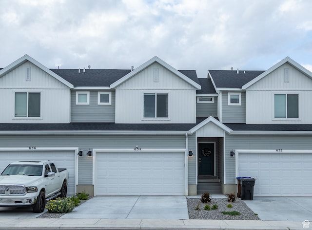 634 W Parker Pl Unit 1060, Grantsville, UT 84029 - multi unit property featuring a garage, concrete driveway, board and batten siding, and a shingled roof