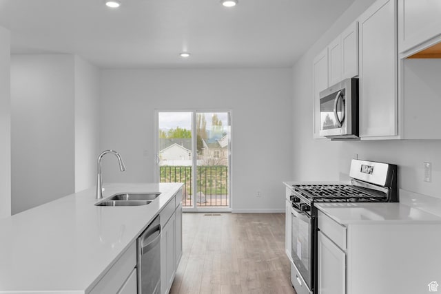 1885 E Thunder Ln Unit 495, Eagle Mountain, UT 84005 - kitchen with stainless steel appliances, a sink, light wood finished floors, light countertops, and recessed lighting