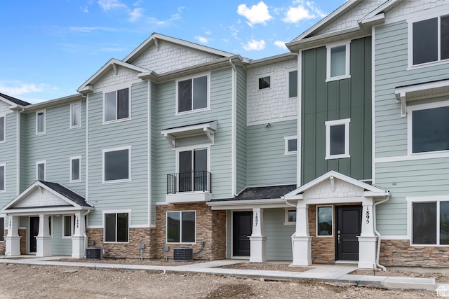 1885 E Thunder Ln Unit 495, Eagle Mountain, UT 84005 - view of front of home featuring stone siding, central AC, and board and batten siding