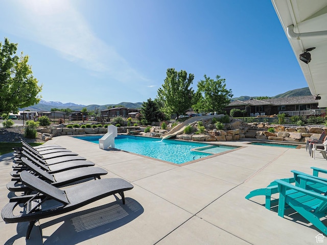 13772 S Kennington Ct E, Draper, UT 84020 - view of pool with a water slide, a mountain view, and a patio area