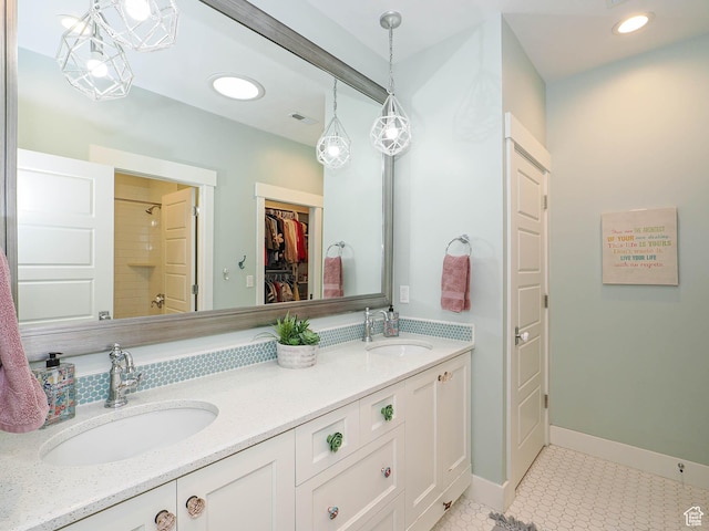 13772 S Kennington Ct E, Draper, UT 84020 - full bathroom with double vanity, tile patterned floors, a shower, a walk in closet, and baseboards
