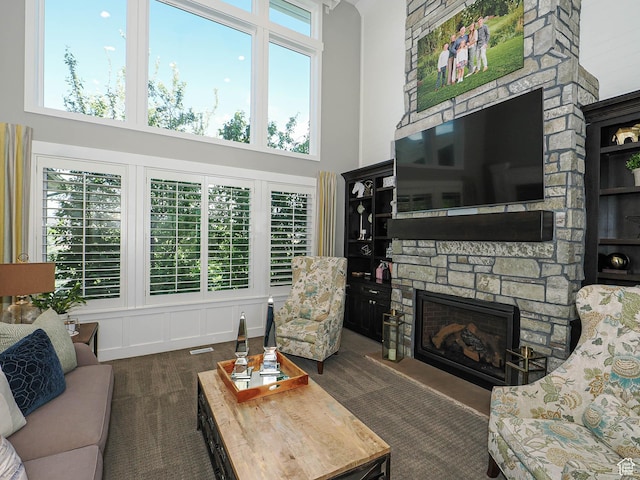 13772 S Kennington Ct E, Draper, UT 84020 - living room with a high ceiling, a fireplace, and dark colored carpet