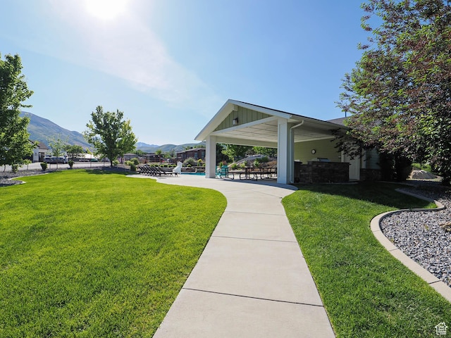 13772 S Kennington Ct E, Draper, UT 84020 - view of home's community featuring a yard, a mountain view, a swimming pool, and a patio