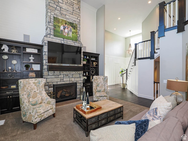 13772 S Kennington Ct E, Draper, UT 84020 - living room featuring stairway, a towering ceiling, a fireplace, dark wood-style floors, and recessed lighting
