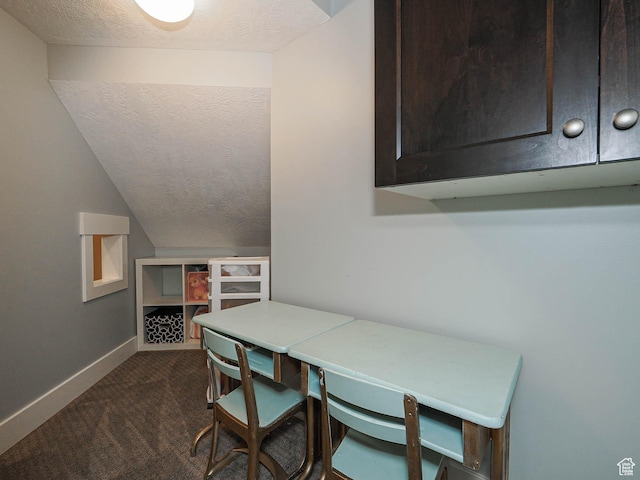13772 S Kennington Ct E, Draper, UT 84020 - dining area featuring dark carpet, a textured ceiling, vaulted ceiling, and baseboards