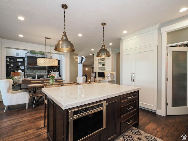 13772 S Kennington Ct E, Draper, UT 84020 - kitchen with dark wood-type flooring, light stone counters, decorative light fixtures, recessed lighting, and a kitchen island