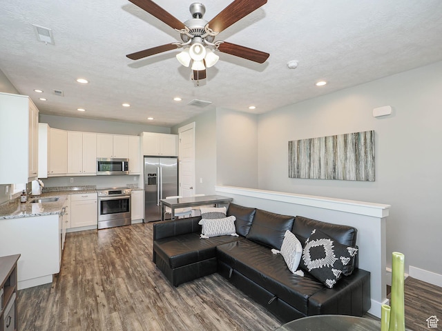 13772 S Kennington Ct E, Draper, UT 84020 - living room with dark wood-style floors, recessed lighting, a ceiling fan, a textured ceiling, and baseboards