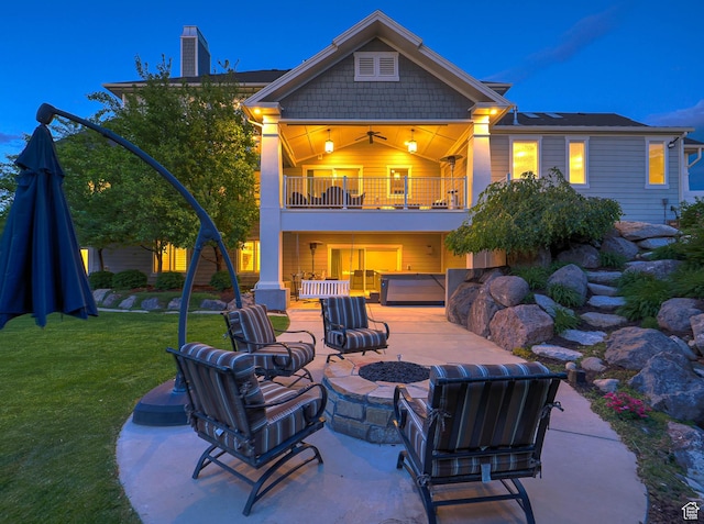 13772 S Kennington Ct E, Draper, UT 84020 - back of house with a balcony, an outdoor fire pit, a patio area, a lawn, and a chimney
