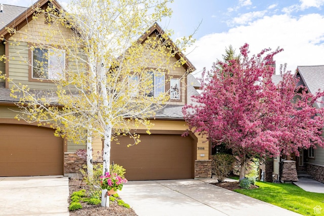 3006 E Canyon Links Dr S, Park City, UT 84098 - craftsman-style house with a garage, driveway, a shingled roof, and stone siding