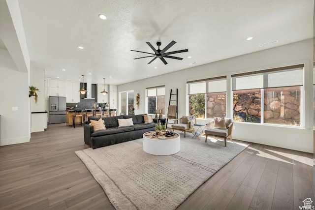 1585 E Black Brush Dr Unit 61, Washington, UT 84780 - living area featuring ceiling fan, wood finished floors, recessed lighting, and baseboards