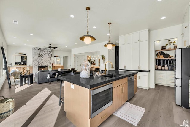 1585 E Black Brush Dr Unit 61, Washington, UT 84780 - kitchen featuring a sink, stainless steel appliances, dark countertops, a ceiling fan, and recessed lighting