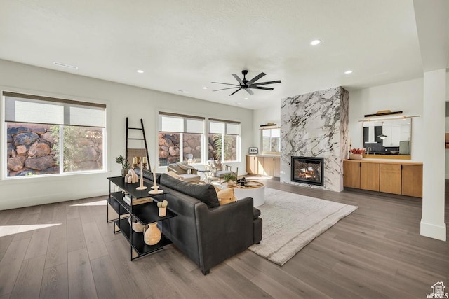 1585 E Black Brush Dr Unit 61, Washington, UT 84780 - living room with wood finished floors, ceiling fan, a fireplace, recessed lighting, and baseboards