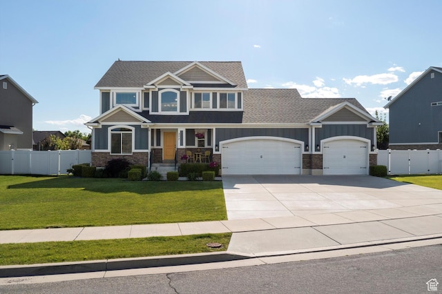 277 N 3600 W, Layton, UT 84041 - craftsman-style house featuring an attached garage, concrete driveway, a shingled roof, stone siding, and board and batten siding
