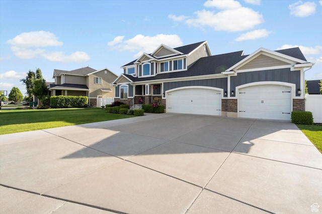 277 N 3600 W, Layton, UT 84041 - view of front facade with board and batten siding, stone siding, a garage, and a front yard