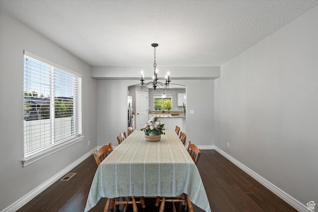 277 N 3600 W, Layton, UT 84041 - dining area featuring a chandelier, dark wood-style floors, baseboards, and a textured ceiling