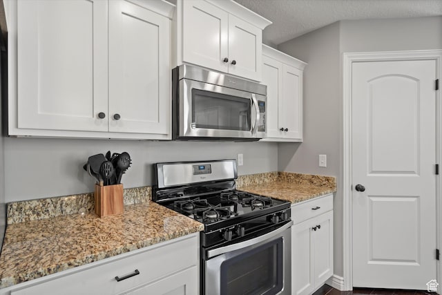 277 N 3600 W, Layton, UT 84041 - kitchen with stainless steel appliances, white cabinets, light stone countertops, and a textured ceiling