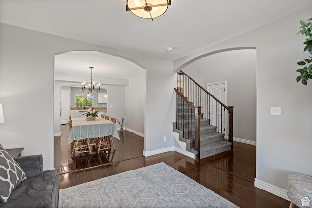 277 N 3600 W, Layton, UT 84041 - entrance foyer with arched walkways, wood finished floors, stairs, baseboards, and a chandelier