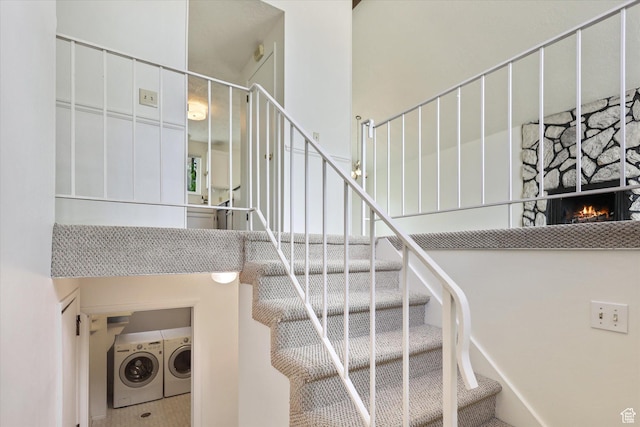 1694 E Plata Way, Sandy, UT 84093 - staircase featuring washing machine and clothes dryer, a high ceiling, and a fireplace