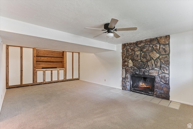 1694 E Plata Way, Sandy, UT 84093 - unfurnished living room featuring carpet, a textured ceiling, a stone fireplace, baseboards, and ceiling fan