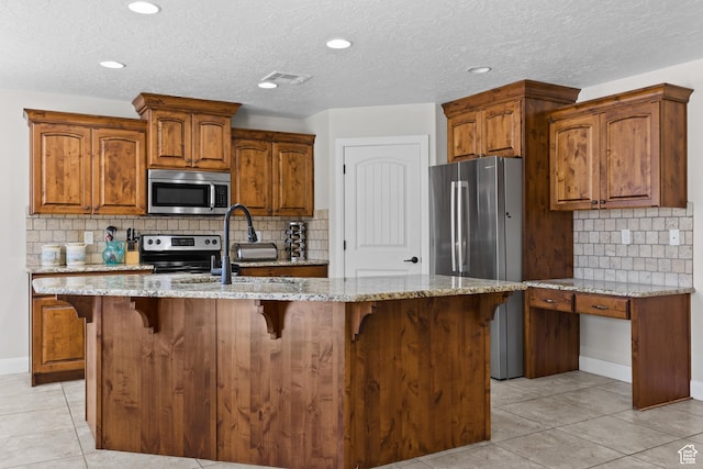 3345 W 2430 S, Hurricane, UT 84737 - kitchen with appliances with stainless steel finishes, light stone countertops, light tile patterned flooring, decorative backsplash, and recessed lighting