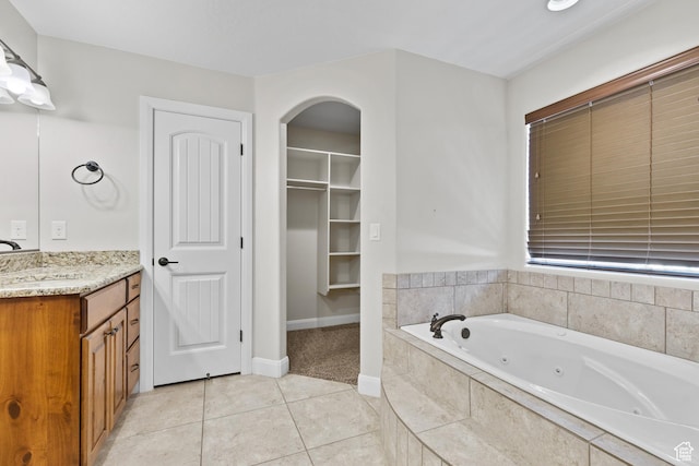 3345 W 2430 S, Hurricane, UT 84737 - bathroom with vanity, a whirlpool tub, tile patterned flooring, baseboards, and a spacious closet