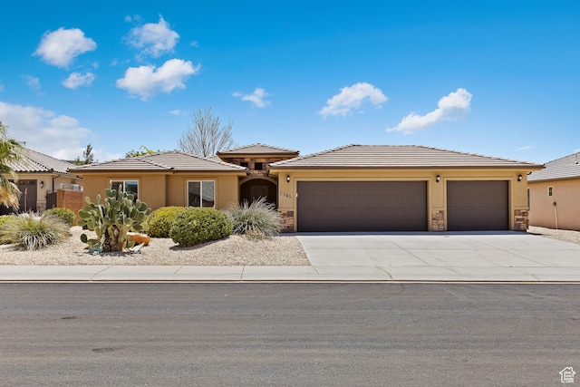 3345 W 2430 S, Hurricane, UT 84737 - prairie-style home featuring a garage, stucco siding, concrete driveway, and stone siding