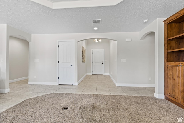 3345 W 2430 S, Hurricane, UT 84737 - foyer entrance featuring arched walkways, light tile patterned floors, a textured ceiling, and baseboards