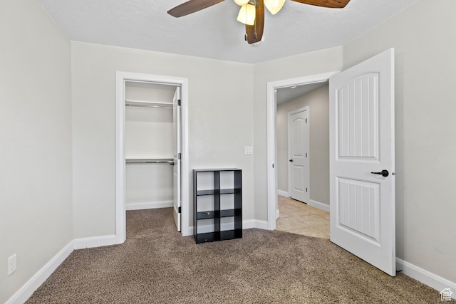 3345 W 2430 S, Hurricane, UT 84737 - unfurnished bedroom featuring carpet flooring, a walk in closet, a closet, a ceiling fan, and baseboards