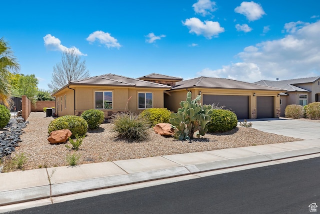 3345 W 2430 S, Hurricane, UT 84737 - view of front facade with an attached garage, driveway, stucco siding, and a tile roof