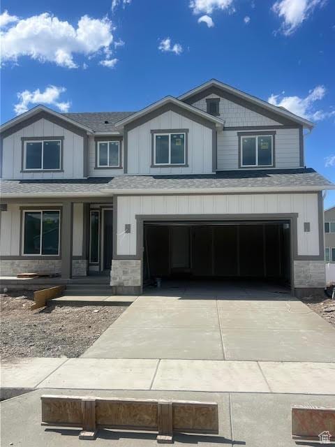 452 W Sapphire Dr Unit 7015, Tooele, UT 84074 - view of front of house featuring an attached garage, concrete driveway, and a shingled roof