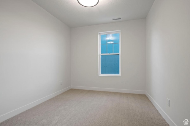 11433 S Watercourse Rd Unit 184, South Jordan, UT 84009 - spare room featuring baseboards and light colored carpet