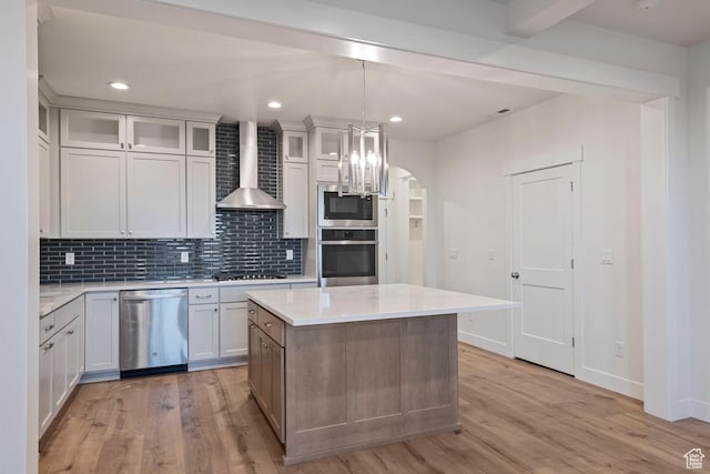 11433 S Watercourse Rd Unit 184, South Jordan, UT 84009 - kitchen featuring appliances with stainless steel finishes, wall chimney exhaust hood, light wood-style flooring, light countertops, and recessed lighting