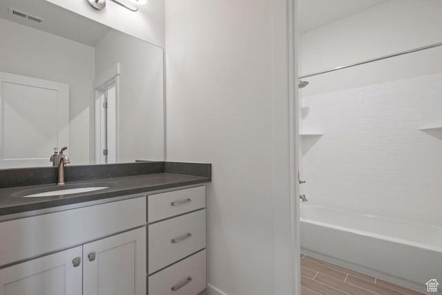 11433 S Watercourse Rd Unit 184, South Jordan, UT 84009 - bathroom with vanity, shower / tub combination, wood finish floors, and baseboards