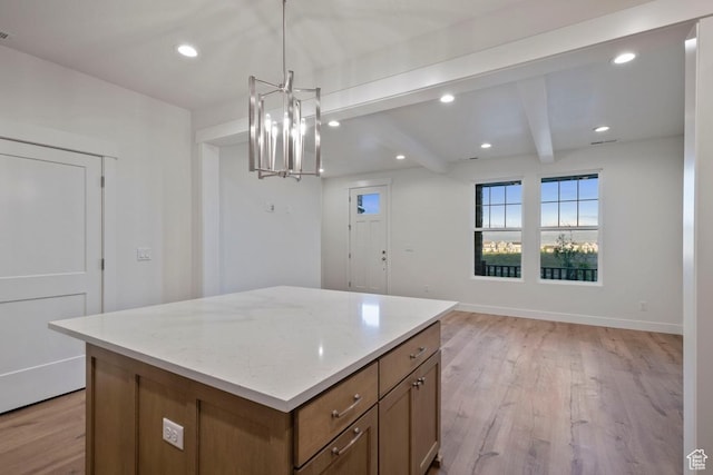 11433 S Watercourse Rd Unit 184, South Jordan, UT 84009 - kitchen with a chandelier, a center island, light wood-type flooring, beamed ceiling, and light stone countertops