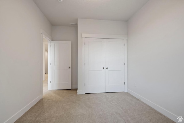 11433 S Watercourse Rd Unit 184, South Jordan, UT 84009 - unfurnished bedroom featuring carpet floors, baseboards, and a closet