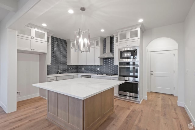 11433 S Watercourse Rd Unit 184, South Jordan, UT 84009 - kitchen with wall chimney range hood, appliances with stainless steel finishes, light countertops, baseboards, and recessed lighting