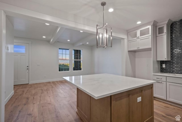 11433 S Watercourse Rd Unit 184, South Jordan, UT 84009 - kitchen with light countertops, tasteful backsplash, beam ceiling, glass insert cabinets, and a kitchen island