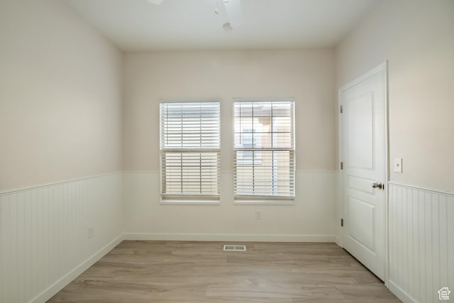 10227 S Oquirrh Lake Rd, South Jordan, UT 84095 - spare room featuring light wood finished floors, wainscoting, and a ceiling fan