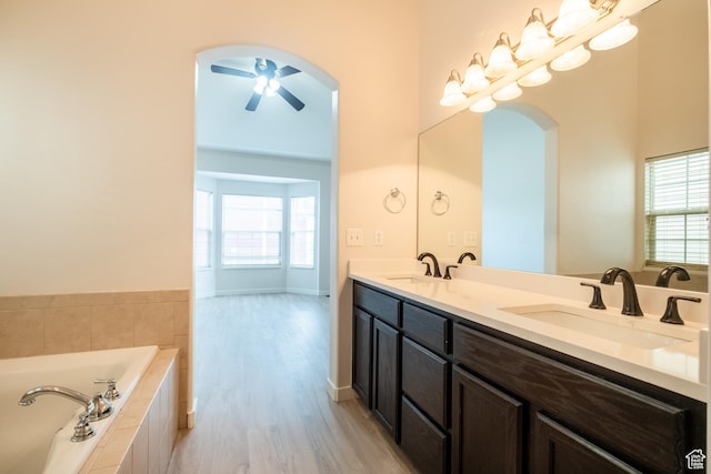 10227 S Oquirrh Lake Rd, South Jordan, UT 84095 - full bath featuring wood finished floors, double vanity, a garden tub, and plenty of natural light