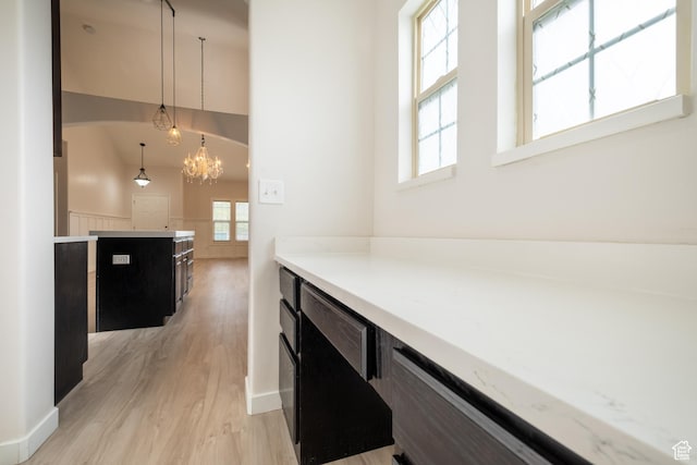 10227 S Oquirrh Lake Rd, South Jordan, UT 84095 - hallway with light wood-style floors and a chandelier