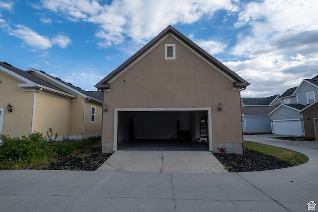 10227 S Oquirrh Lake Rd, South Jordan, UT 84095 - view of property exterior featuring concrete driveway, an attached garage, and stucco siding